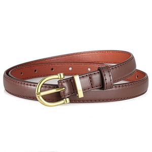 Close-up of dark brown slim leather belt featuring a matte gold horseshoe buckle and stitching