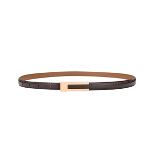 Detail of slim brown leather belt with polished gold rectangular buckle and precise stitching