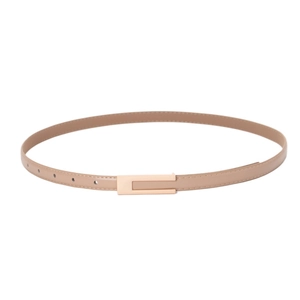 Detail of slim camel leather belt with refined texture and light gold rectangle buckle