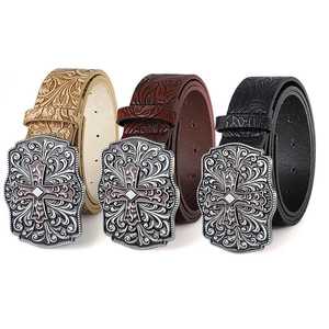 Close-up of vintage carved cross buckles on embossed leather belts in three colors