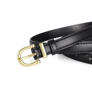 Close-up of black leather slim belt with gold horseshoe buckle and fine stitching detail