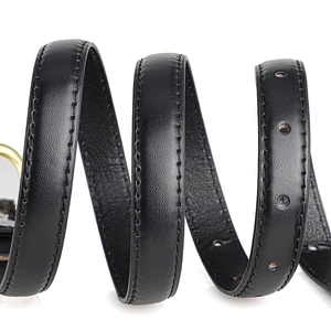 Close-up of black leather belt with natural grain texture and fine stitching detail