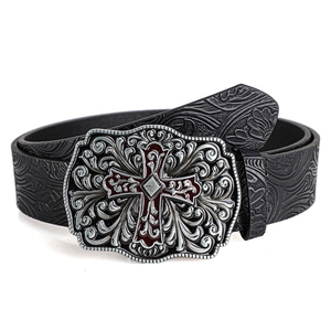 Detail of vintage belt buckle with silver floral relief and red cross emblem on black leather