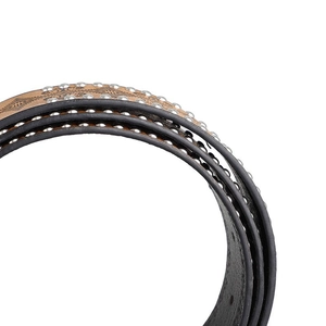 Close-up of Western vintage leather belt with floral embossing and silver metal studs