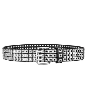 Macro detail of black punk leather belt with three rows of silver metal eyelets