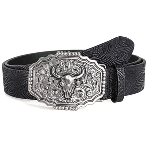 Macro detail of western bull skull alloy buckle and embossed black leather belt