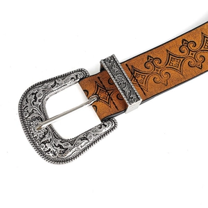 Close-up of vintage western belt showing embossed brown leather and engraved silver buckle