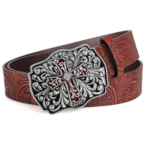 Close-up of vintage brown leather belt with floral embossing and silver cross buckle