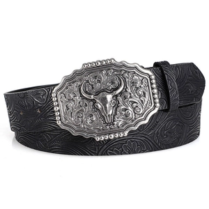 Close-up of western style leather belt with floral embossing and bull head metal buckle
