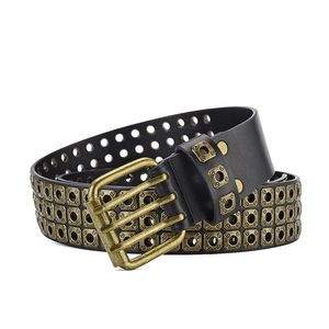 Macro detail of heavy metal three-row square bronze rivets on black punk leather belt