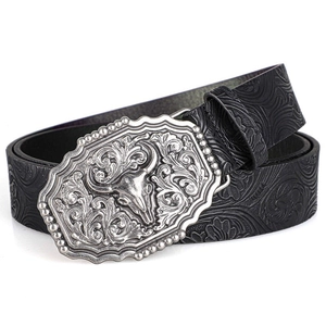Close-up of vintage western belt with embossed floral patterns and silver bull head buckle