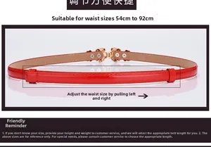 Detail of red patent leather belt with gold flower buckle and adjustable sliding mechanism