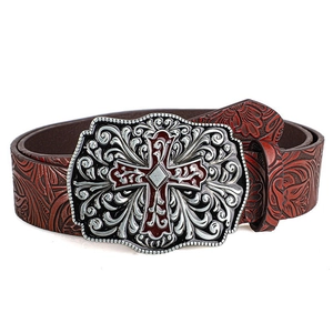 Vintage western style leather belt with embossed patterns and silver cross buckle