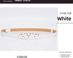 Detail view of white patent leather belt with golden plum blossom enamel buckle