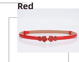 Detail of red patent leather belt with four delicate enamel floral buckles and gold edges