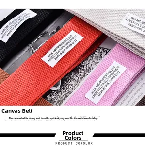 Detailed view of colorful canvas belts with double-ring buckles and woven label accents