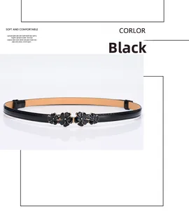 Detail of slim black leather belt featuring gold-trimmed flower buckles for dresses