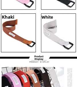 Close-up of canvas belt with black double D-ring buckle and brand tag in multiple colors