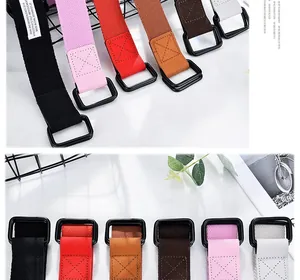 Close-up of double D-ring metal buckle and reinforced stitching on canvas belt