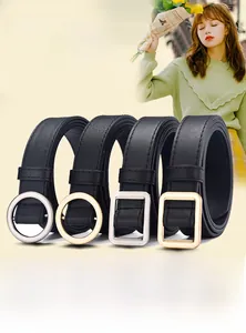Detail of four black leather belts with various gold and silver metal buckles for jeans