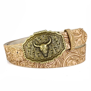 Detail of western bull skull alloy buckle and floral embossed brown leather belt