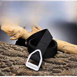 Tactical nylon belt detail with matte silver D-ring buckle on rugged wood background