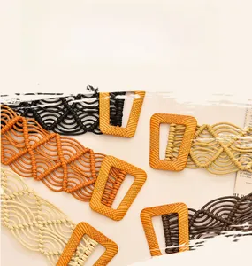 Detailed view of handmade wax rope woven belts with decorative wood texture buckles