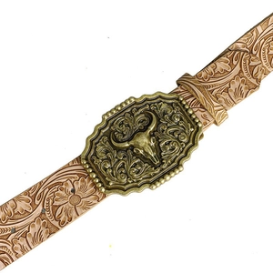 Detailed close-up of a vintage bull head alloy buckle on a Western carved leather belt