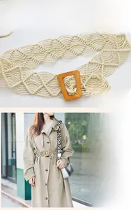 Close-up of beige woven wide waist belt with vintage wooden buckle and hollow wave patterns