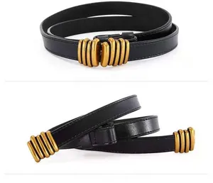 Detail of black leather belt with a vintage gold multi-loop threaded buckle closure