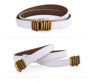Detail of white leather skinny belt for women with a vintage gold ribbed metal buckle