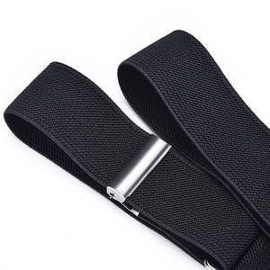 Close-up of black elastic belt with polished silver metal buckle for jeans and trousers