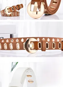 Détail d'une ceinture en cuir tendance avec œillets métalliques et boucle dorée ronde