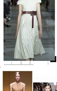 Detail showing a stylish brown leather wide corset belt paired with a white striped dress