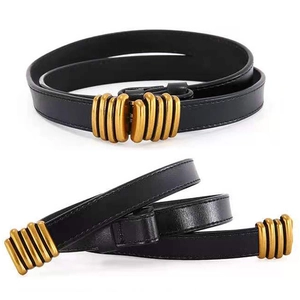 Slim black leather belt for women featuring a vintage textured gold buckle on white background