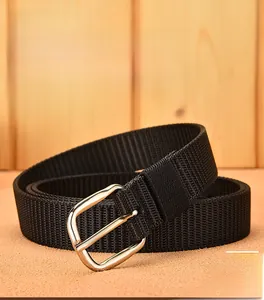 Detail view of black woven canvas belt featuring a polished silver metal pin buckle