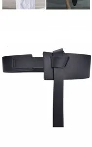 Detail of black pebbled leather wide corset belt with wrap-around tie closure for dresses