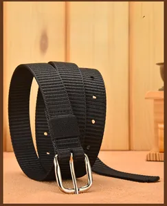 Detail of black woven canvas belt featuring a silver alloy pin buckle and ventilation holes