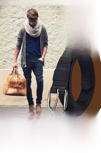 Detail of black woven nylon belt for women with silver metal buckle and refined stitching