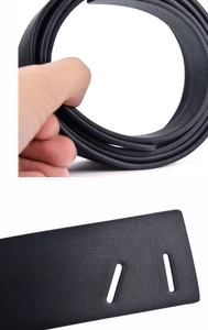 Detail showing the flexible black litchi pattern leather belt texture and punched holes