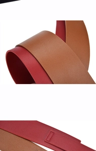 Detail showing dual-sided red and brown leather belt with premium lychee grain texture