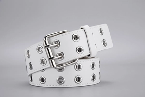 Detail of white punk leather belt with double grommet holes and silver metal pin buckle