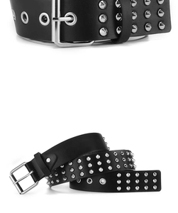 Detail of a punk black leather belt with three rows of silver metal cone rivets and pin buckle
