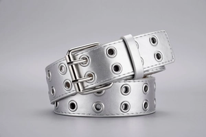 Close-up of punk style double eyelet belt with polished silver double pin buckle detail