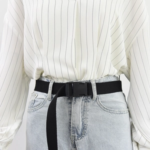 Black canvas belt with plastic buckle for outdoor jeans, shown on a male model waist