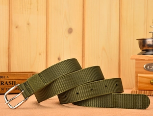 Detailed view of army green nylon tactical belt with a polished silver metal buckle