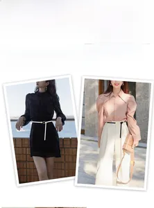 Detail showing slim black and white waist belts with gold metal buckles for dresses