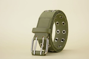 Detailed view of army green canvas belt featuring a silver double-prong metal buckle