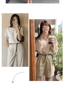Detail of slim black leather belt with golden metal ring buckle on high waist pants