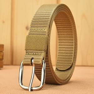 Outdoor khaki canvas belt with silver alloy pin buckle on a textured wood and sand base